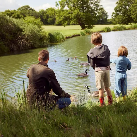 Family enjoying a walk beside the Coworh Park lake