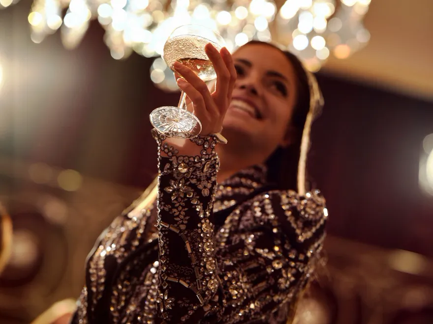 Woman with her glass in Le Salon Haute Couture, at Hôtel Plaza Athénée, Paris - Dorchester Collection.