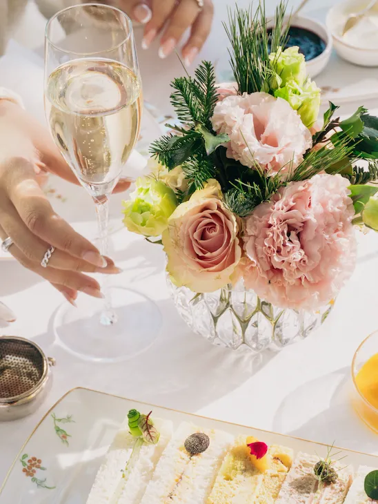 A close up at a champagne glass and sandwiches in The Gallery