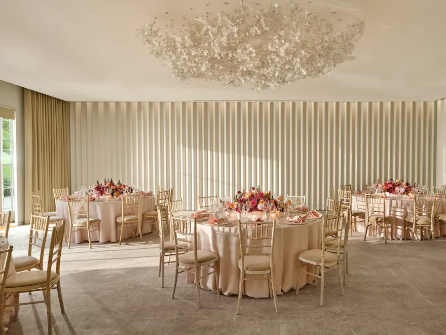 Round tables set for a social event in the Garden Room at Coworth Park