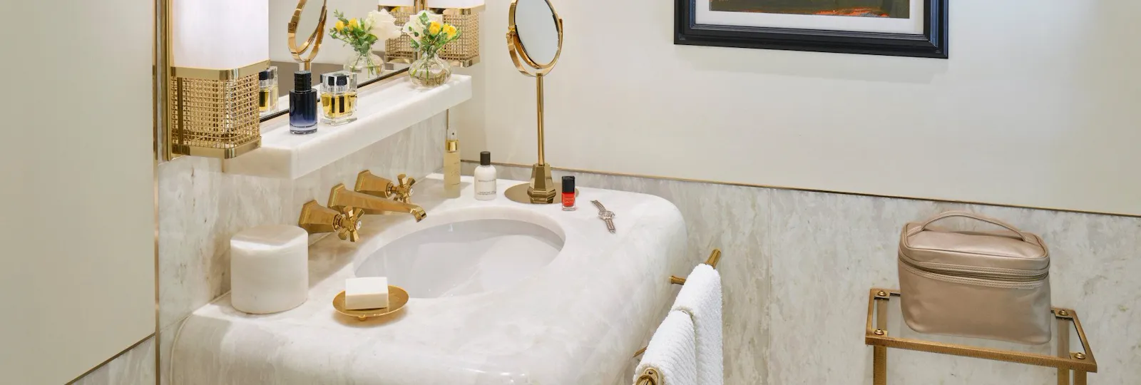 Bathroom of classic room with white marble sink and paintings at Hotel Eden, Rome