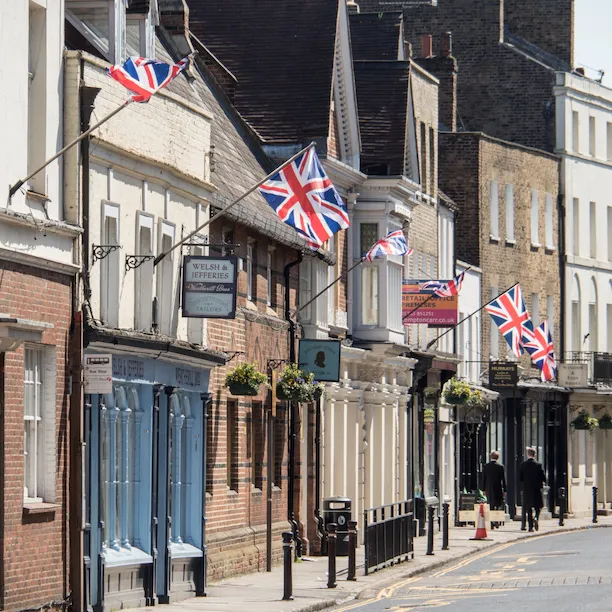 Line of shops on the side of a road in sunny Windsor town centre,Berkshire