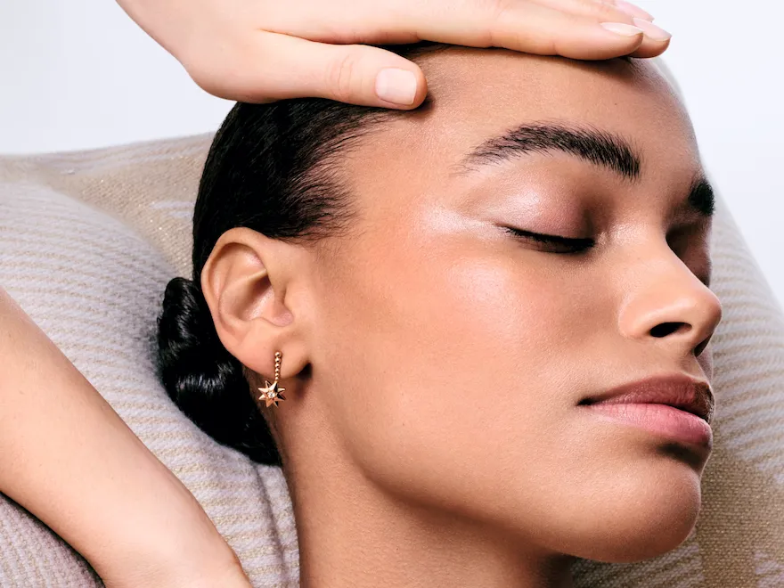 A woman is receiving a facial treatment at Dior Spa Plaza Athénée