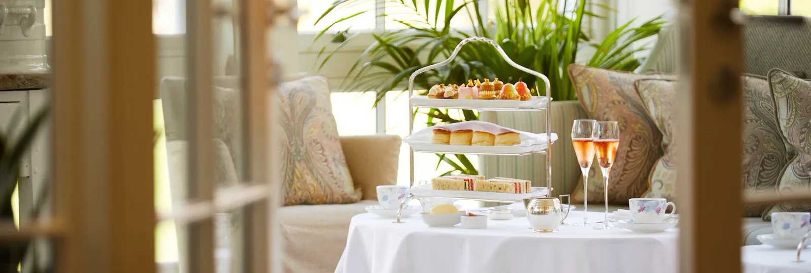 Afternoon tea and champagne on table in Drawing room conservatory