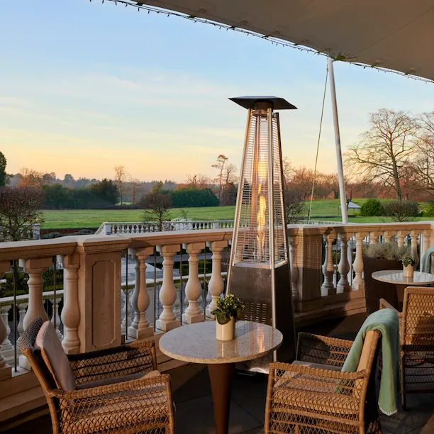 coworth park drawing room terrace at sunset with crisp winter air and heater lamps and blankets