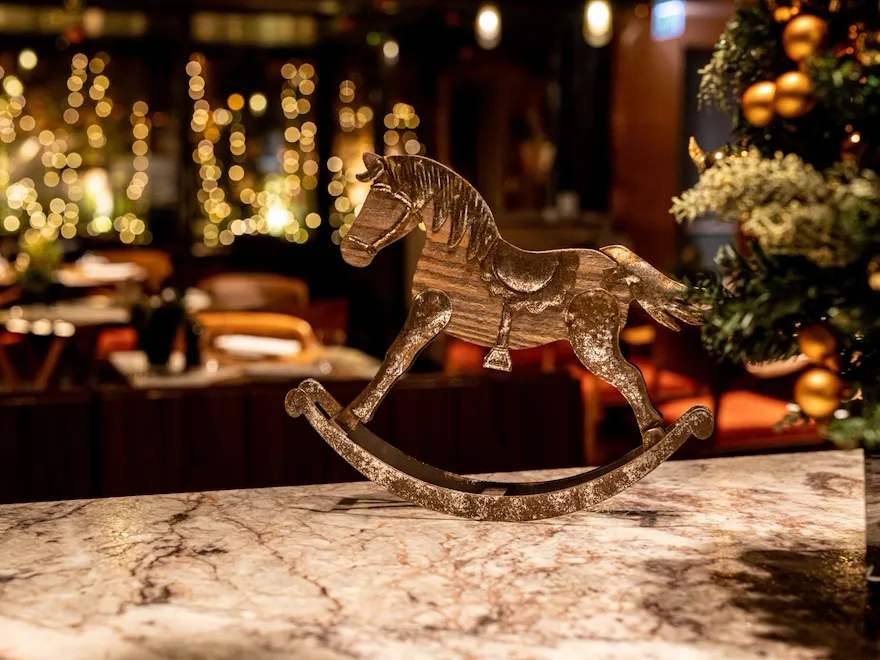Christmas horse decoration and fairy lights in the background at Il Giardino Ristorante at Hotel Eden, Rome