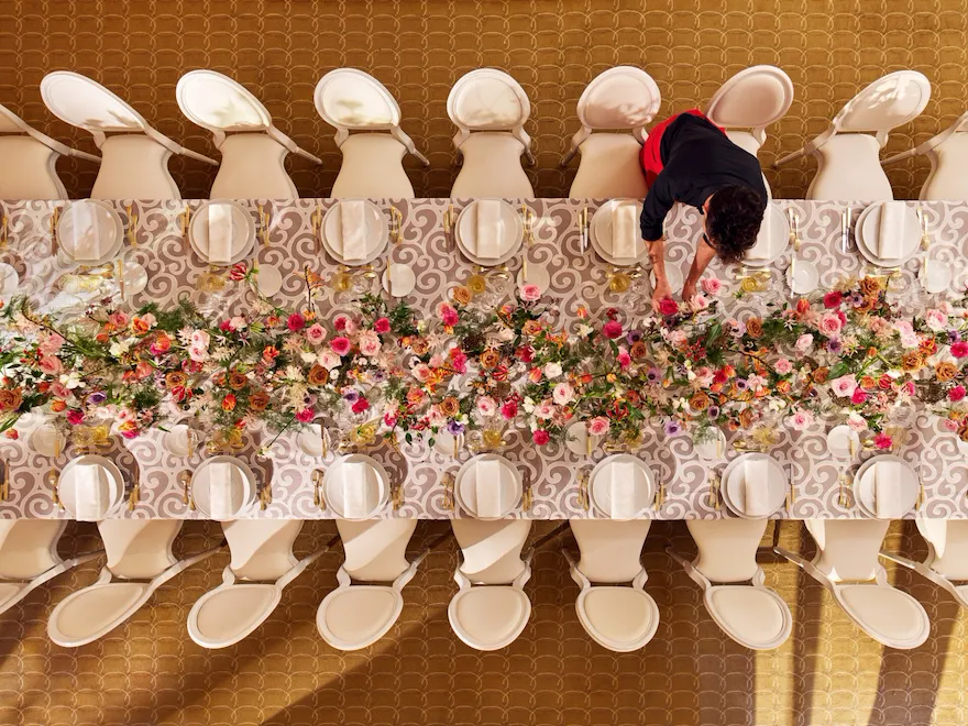 Table captured from the top with colorful flower arrangement at Le Salon Organza, Hôtel Plaza Athénée, Paris - Dorchester Collection.