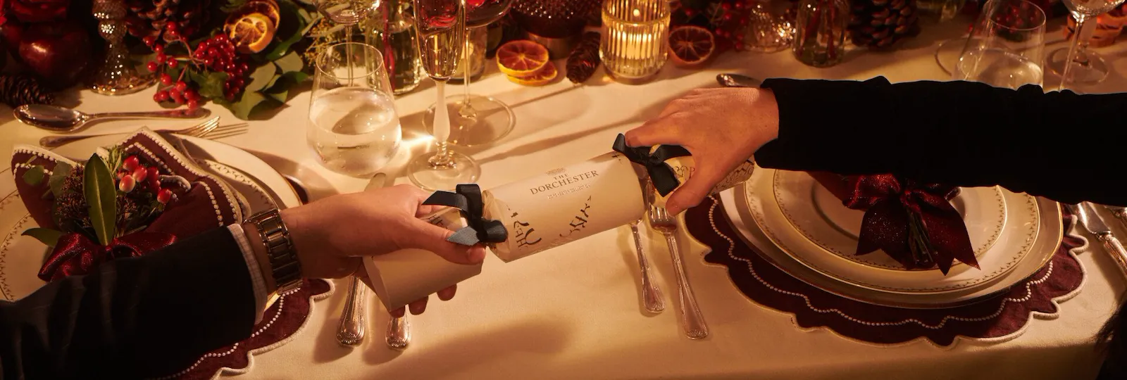 Festive Events at The Dorchester - Two guests pulling a Dorchester Christmas cracker