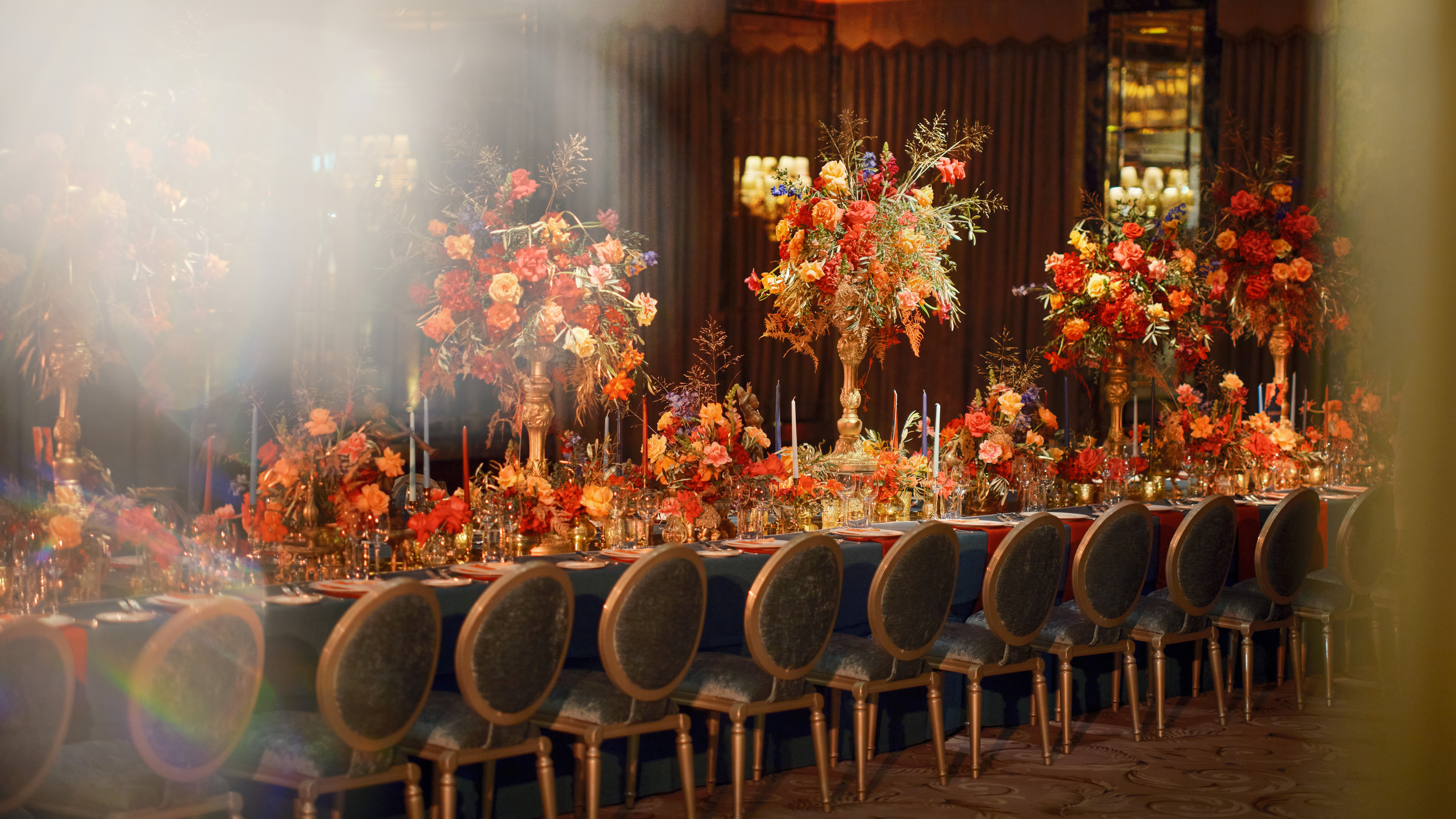The Dorchester Events Ballroom with orange florals