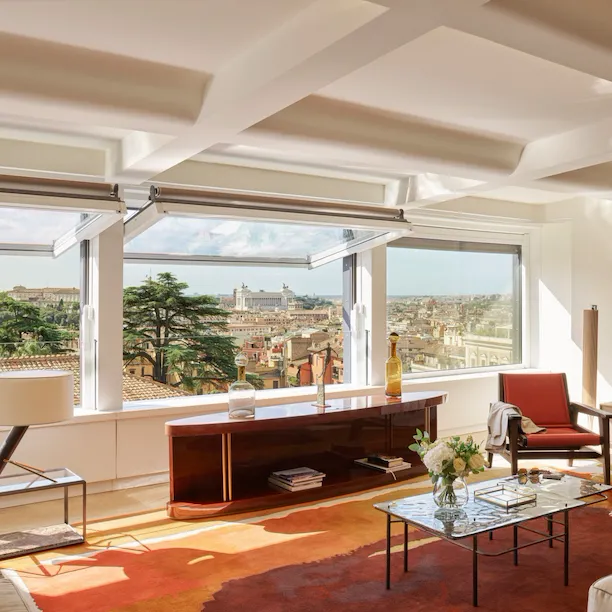 Bellavista Penthouse Suite living room with windows open and view at Hotel Eden, Rome