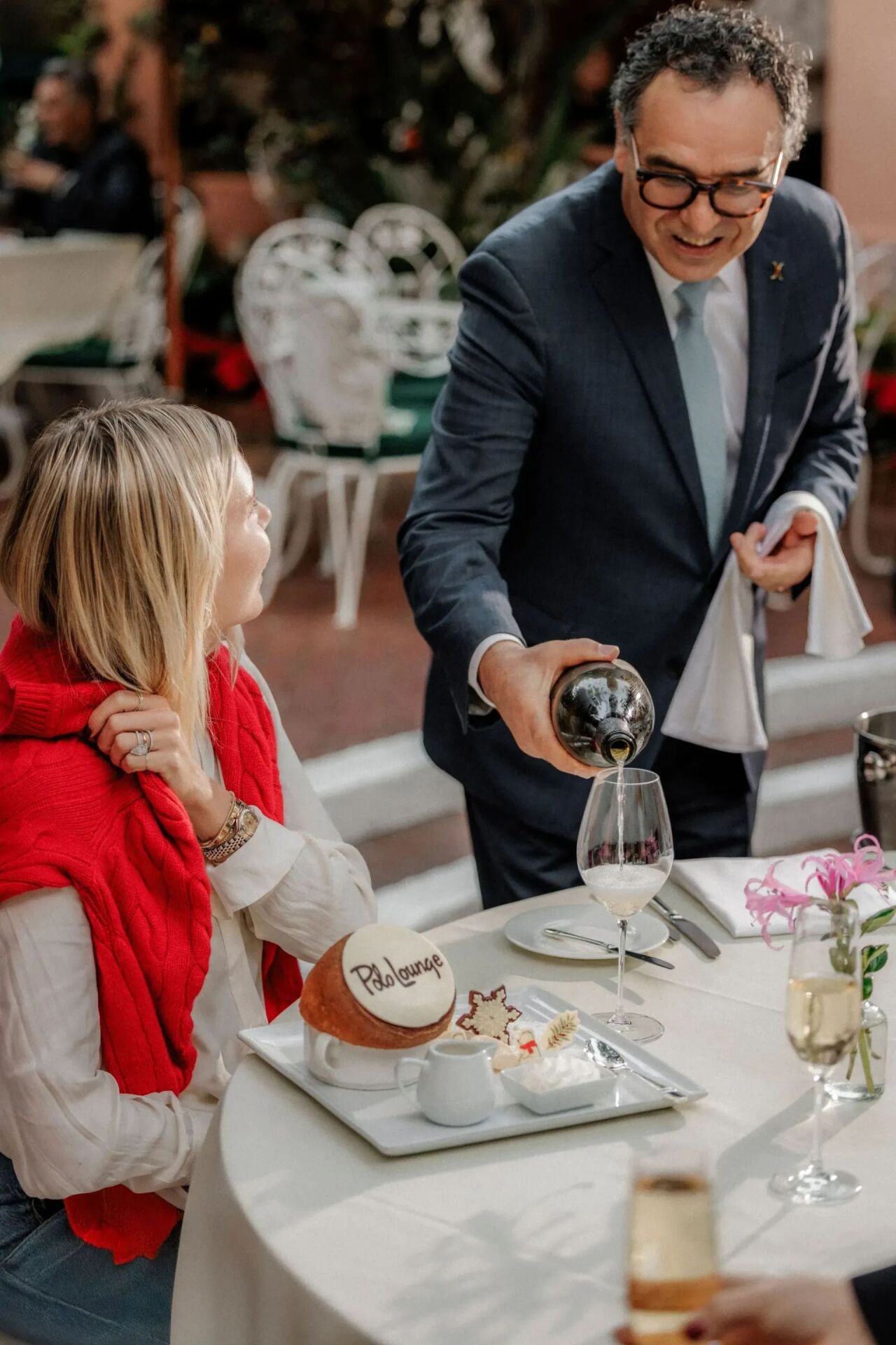 Pepe pouring wine on Polo Lounge patio during festive season 