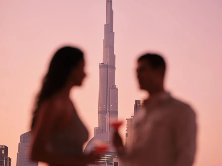 A couple enjoying drinks with the view of Burj Khalifa.