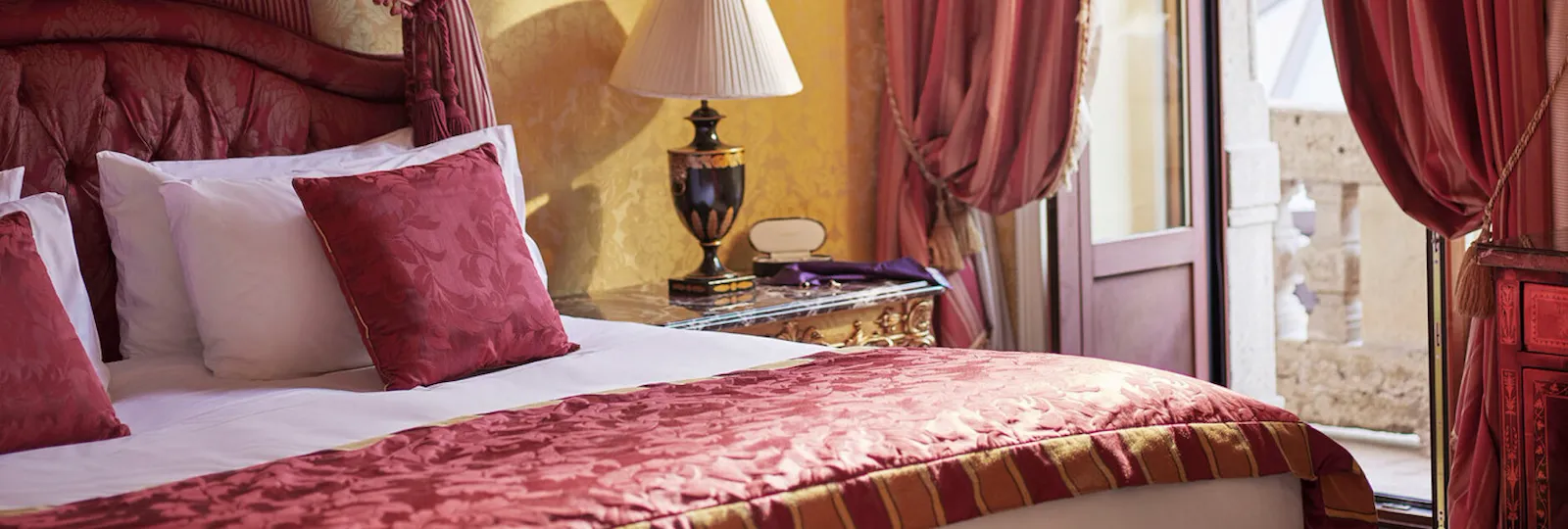 Royal Suite Bedroom Close-up showing the bed and the curtains decorated in red