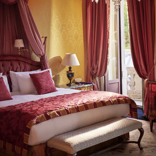 Royal Suite Bedroom Close-up showing the bed and the curtains decorated in red