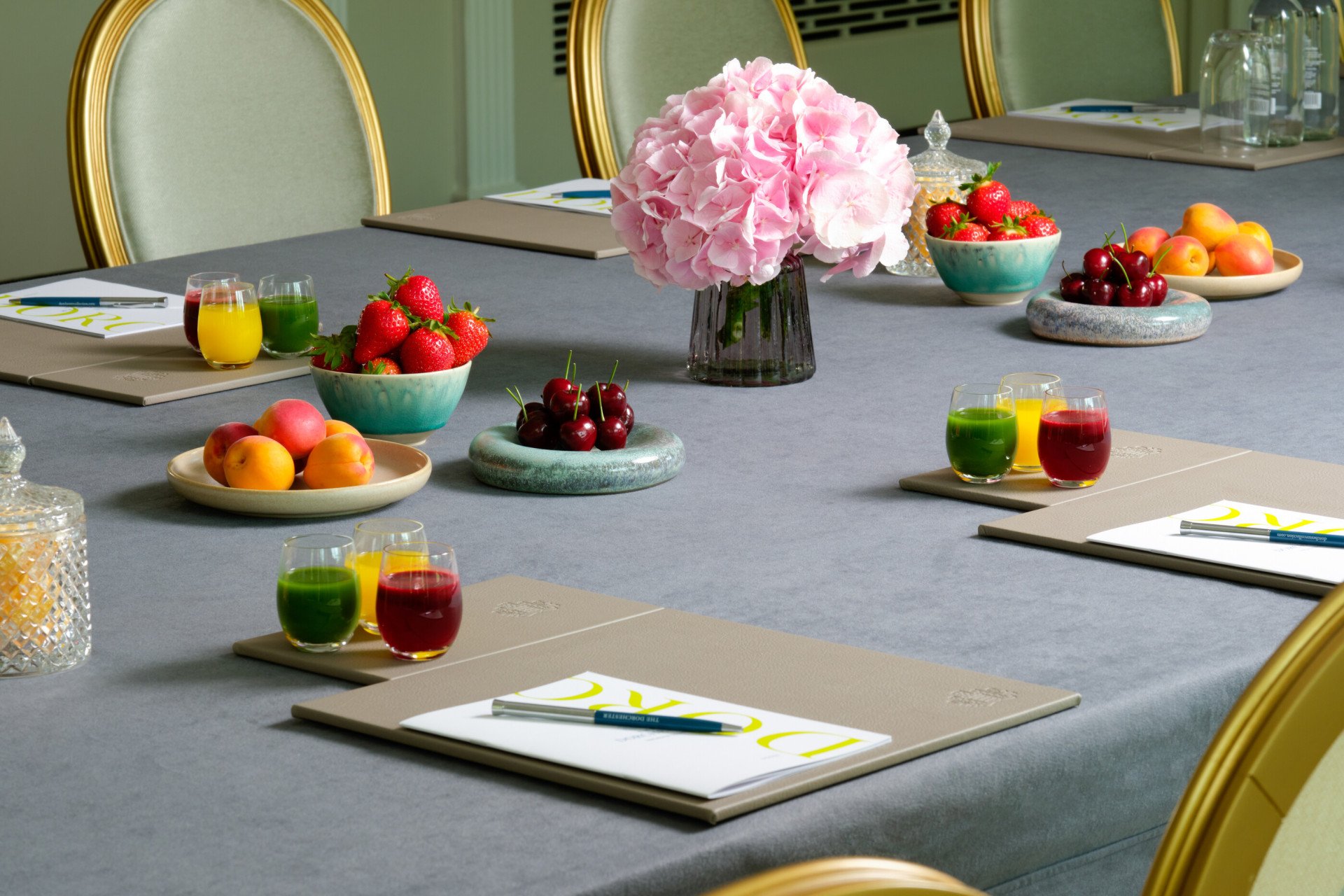 Park Suite at The Dorchester set for meeting with stationary and selection of juices