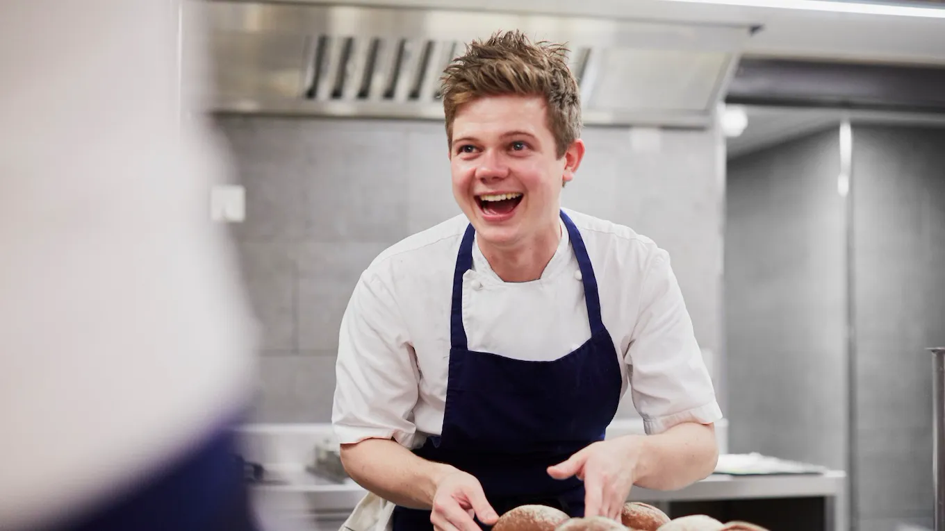 Head Chef Tom Booton preparing a dish in kitchen