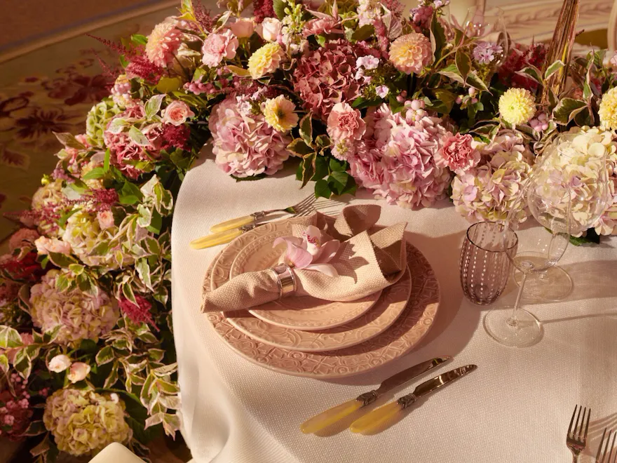 The Dorchester Gold and Silver event space set for fabulous evening event with a stunning floral centre piece - close up of table setting