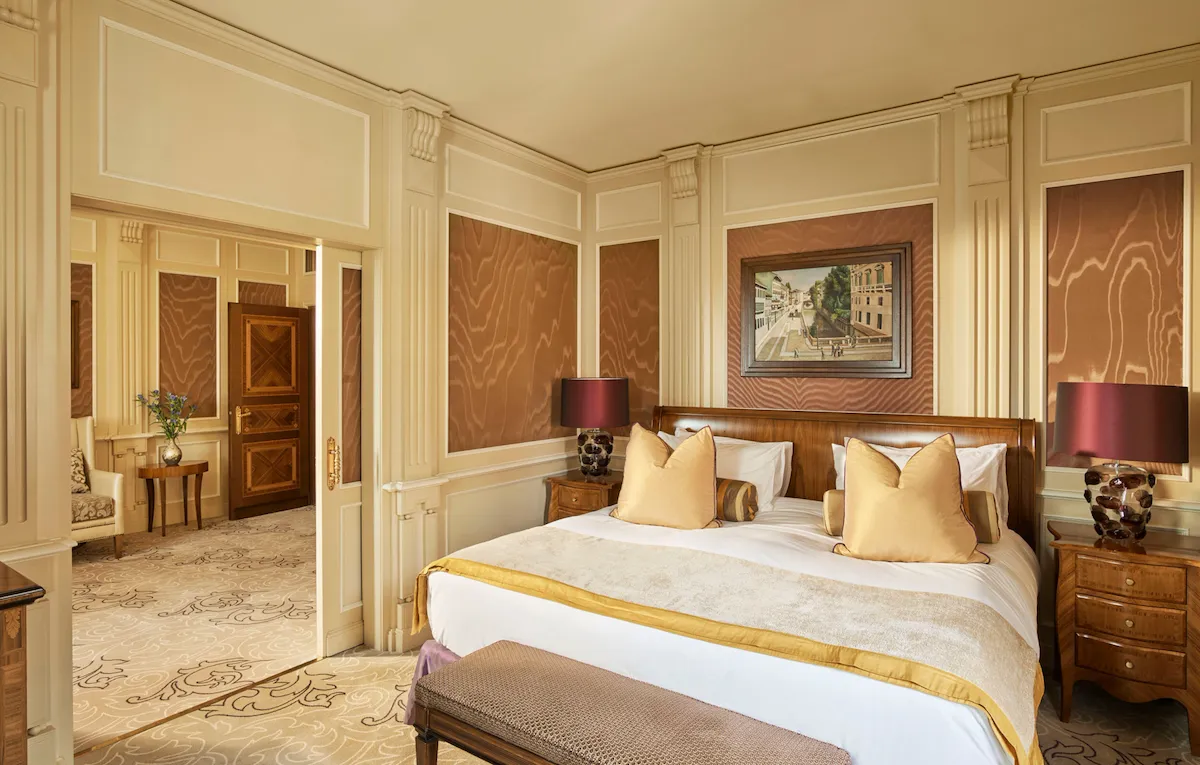 Ambassador Suite Bedroom decorated with warm colors but also touches of yellow and purple color