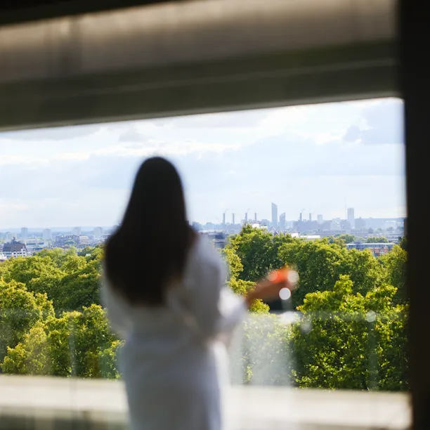 Lady looking over Hyde Park from suite