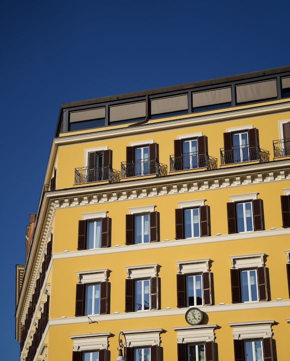 Hotel Eden's yellow exterior building façade, Rome