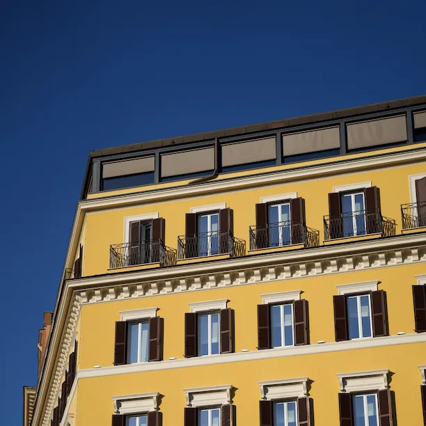 Hotel Eden's yellow exterior building façade, Rome