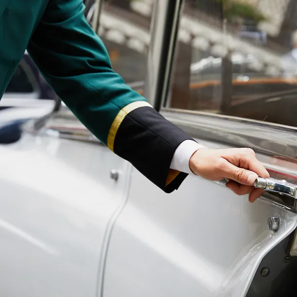 Door man holding the guest's car door handle