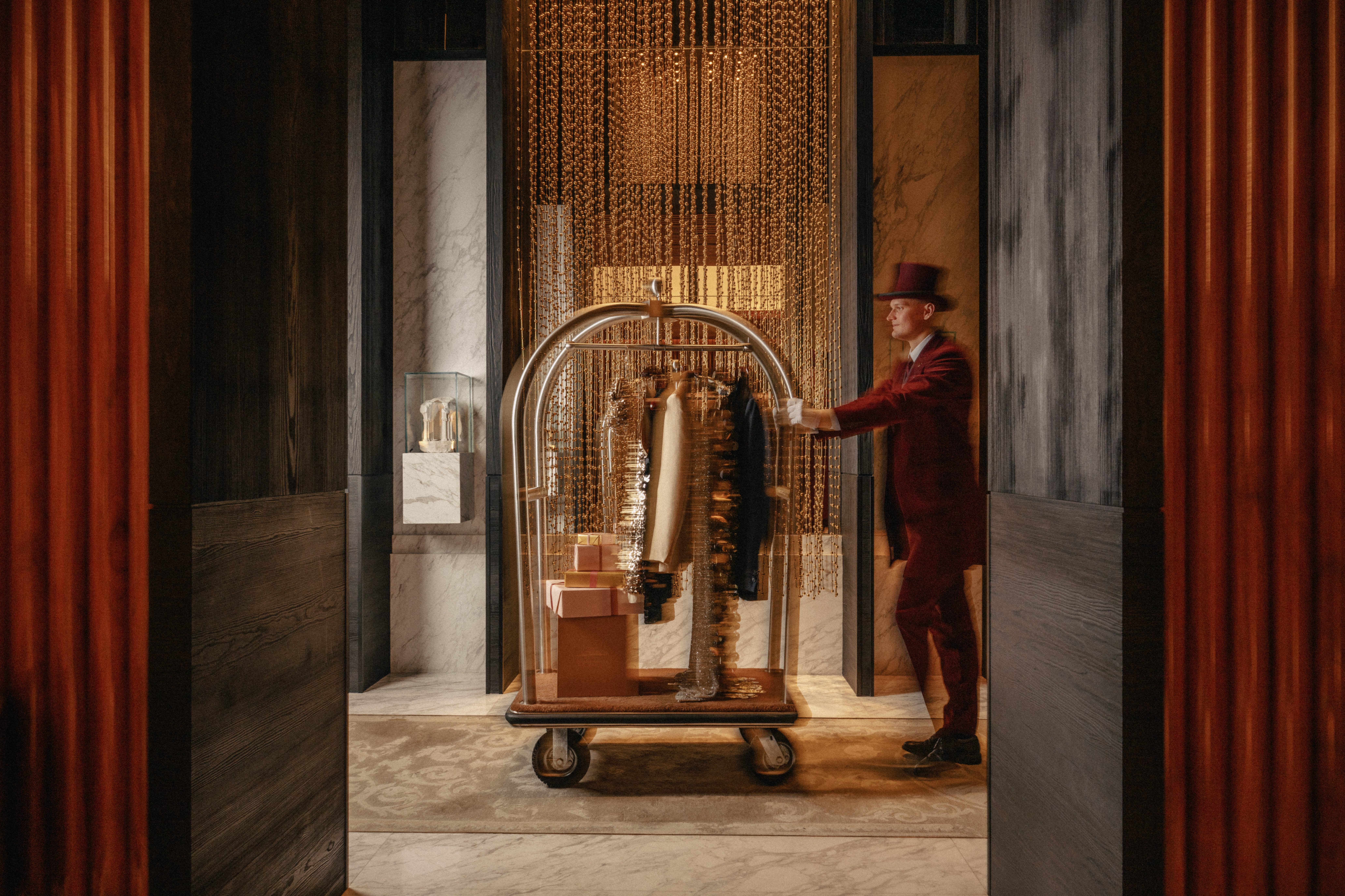 The bellboy with clothes hanging
