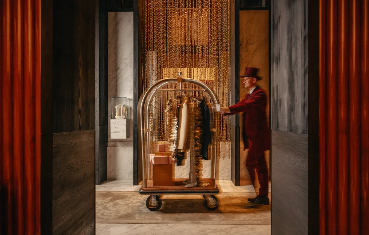The bellboy with clothes hanging