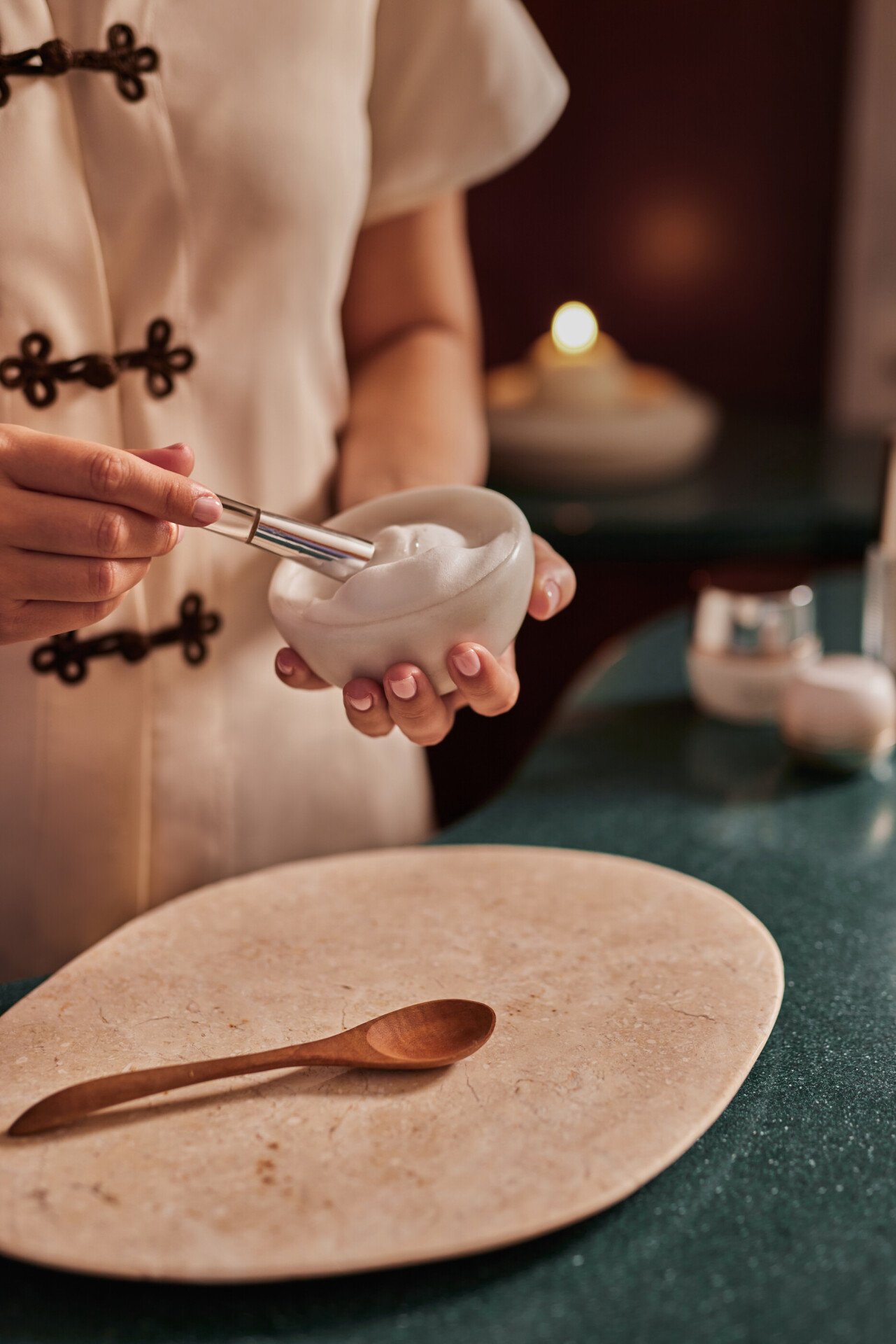spa attendant preparing massage supplies