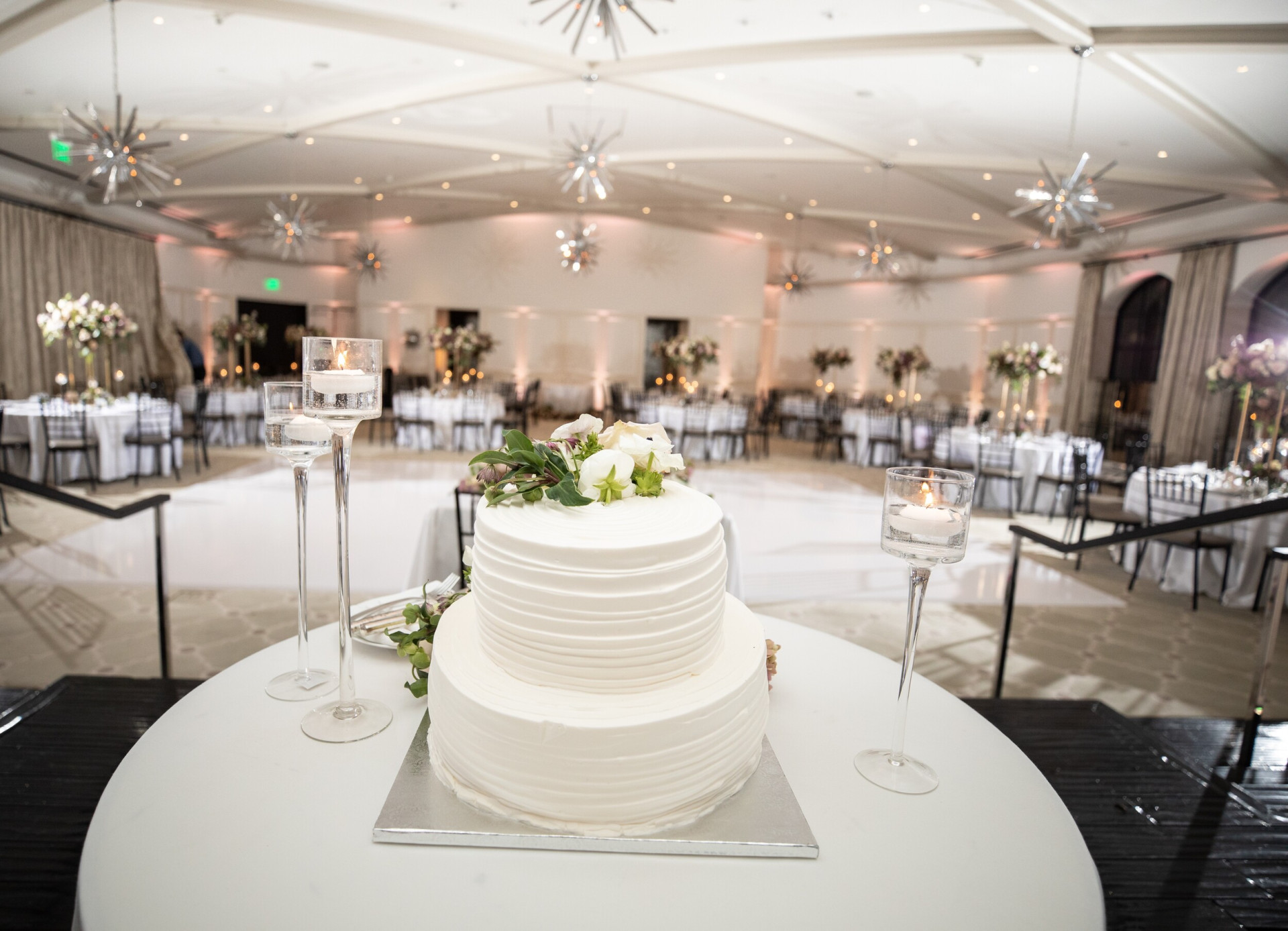 Classic white frosted wedding cake with flowers at Hotel Bel-Air