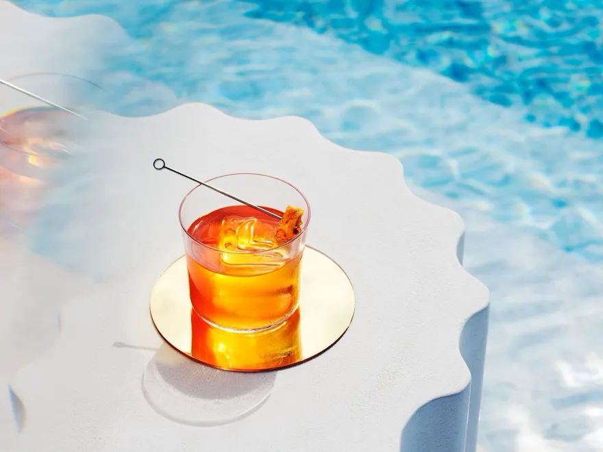 Images of various cocktails and interiors at High Society, The Lana, Dorchester Collection, Dubai in front of different settings and views.