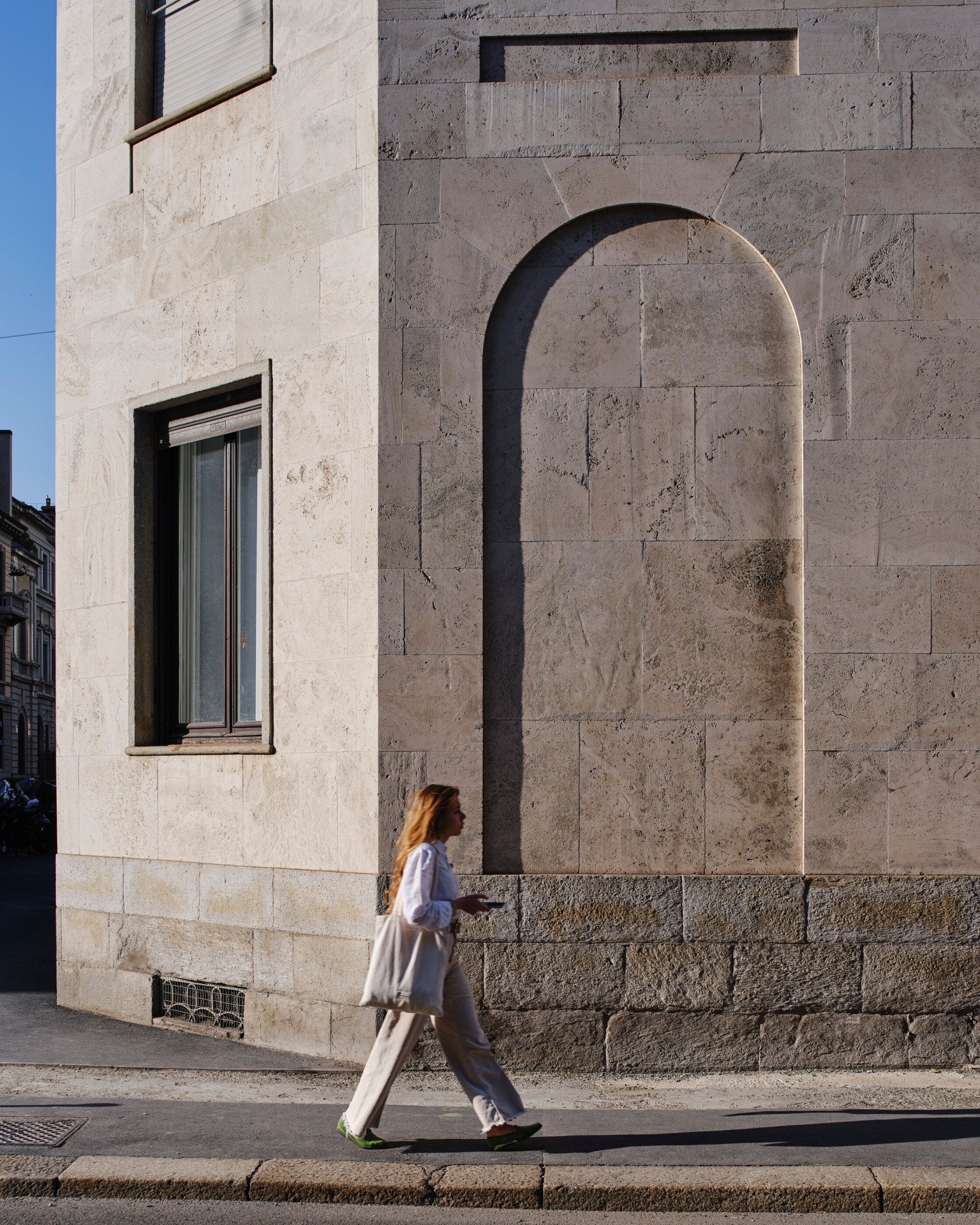 Detail of Ca' Brutta building by Giovanni Muzio with a female figure walking in the foreground