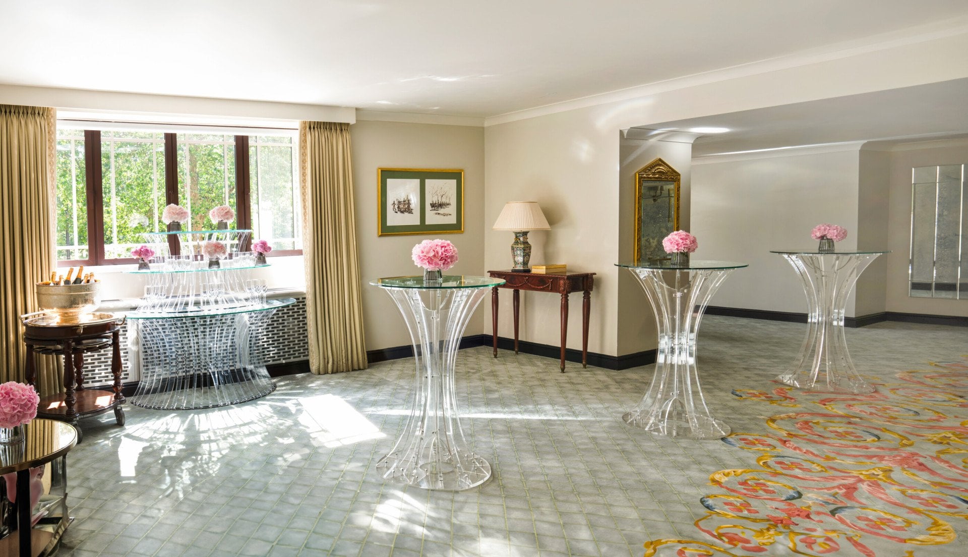 Park Suite with smaller glass tables and pink flowers