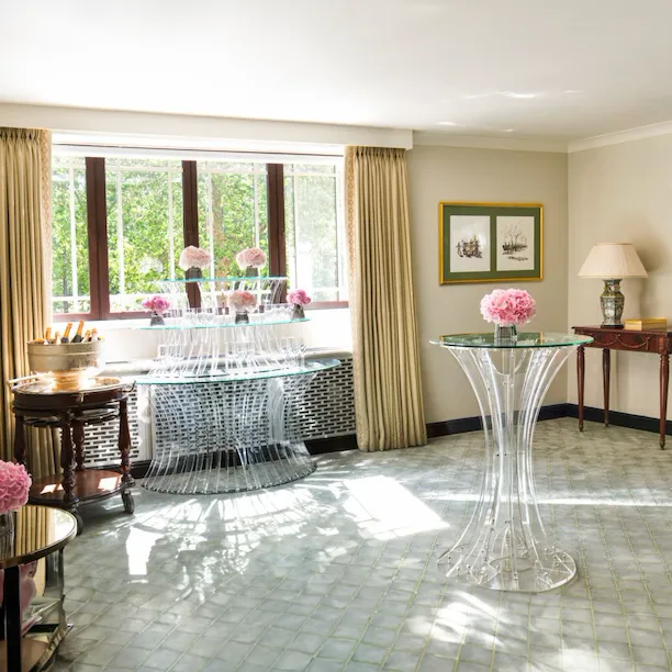 Park Suite with smaller glass tables and pink flowers